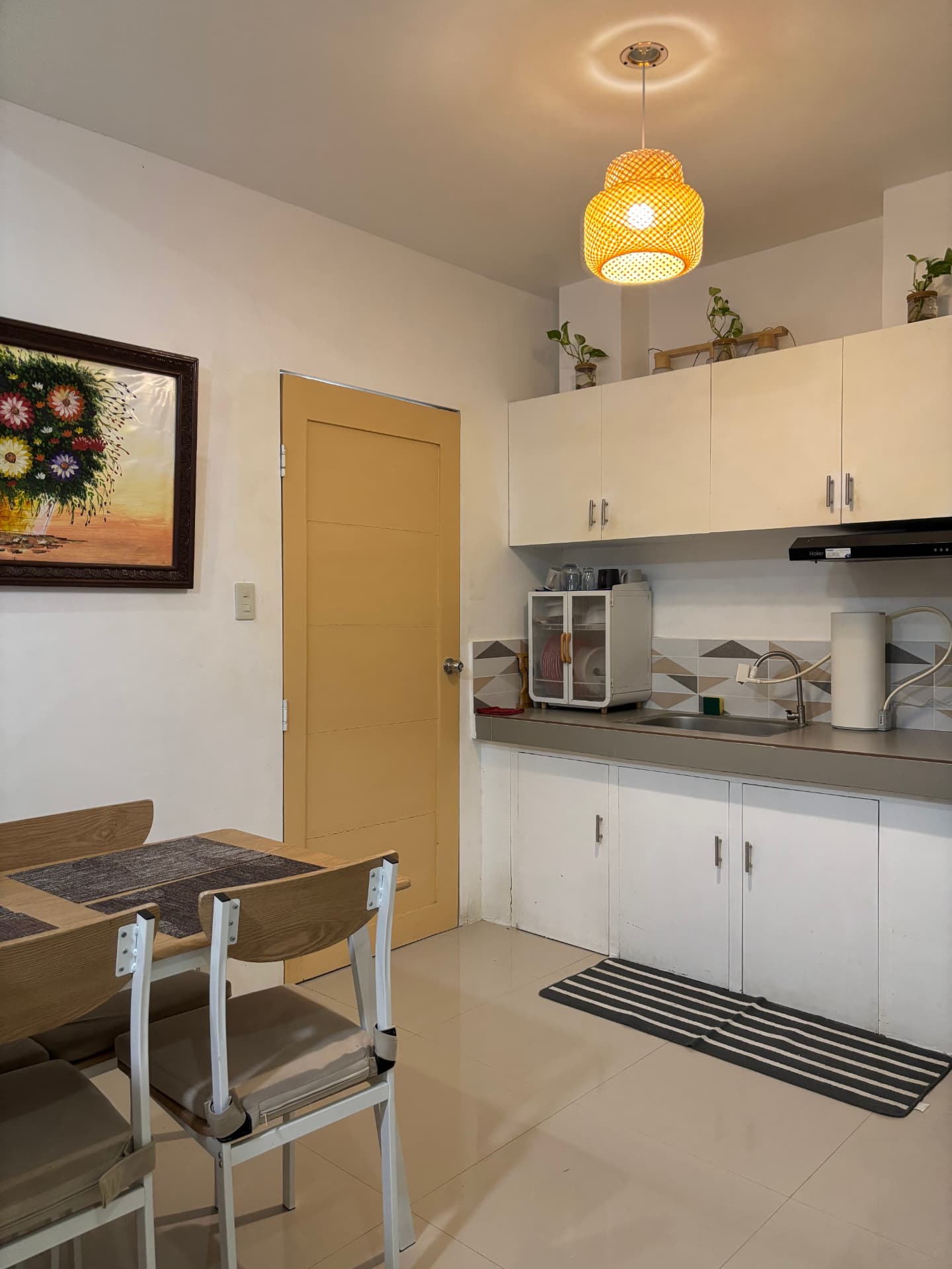 Full kitchen with dining table, cabinets, and sink